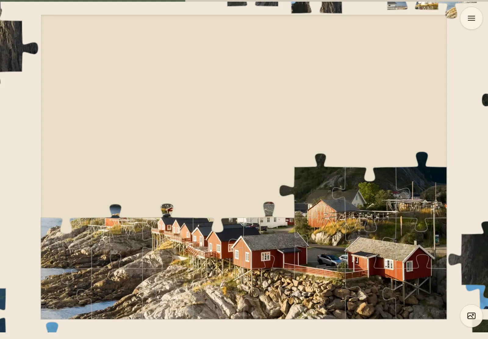 the same photograph part-assembled on a tablet screen, the joined pieces standing on the board and loose ones scattered around it